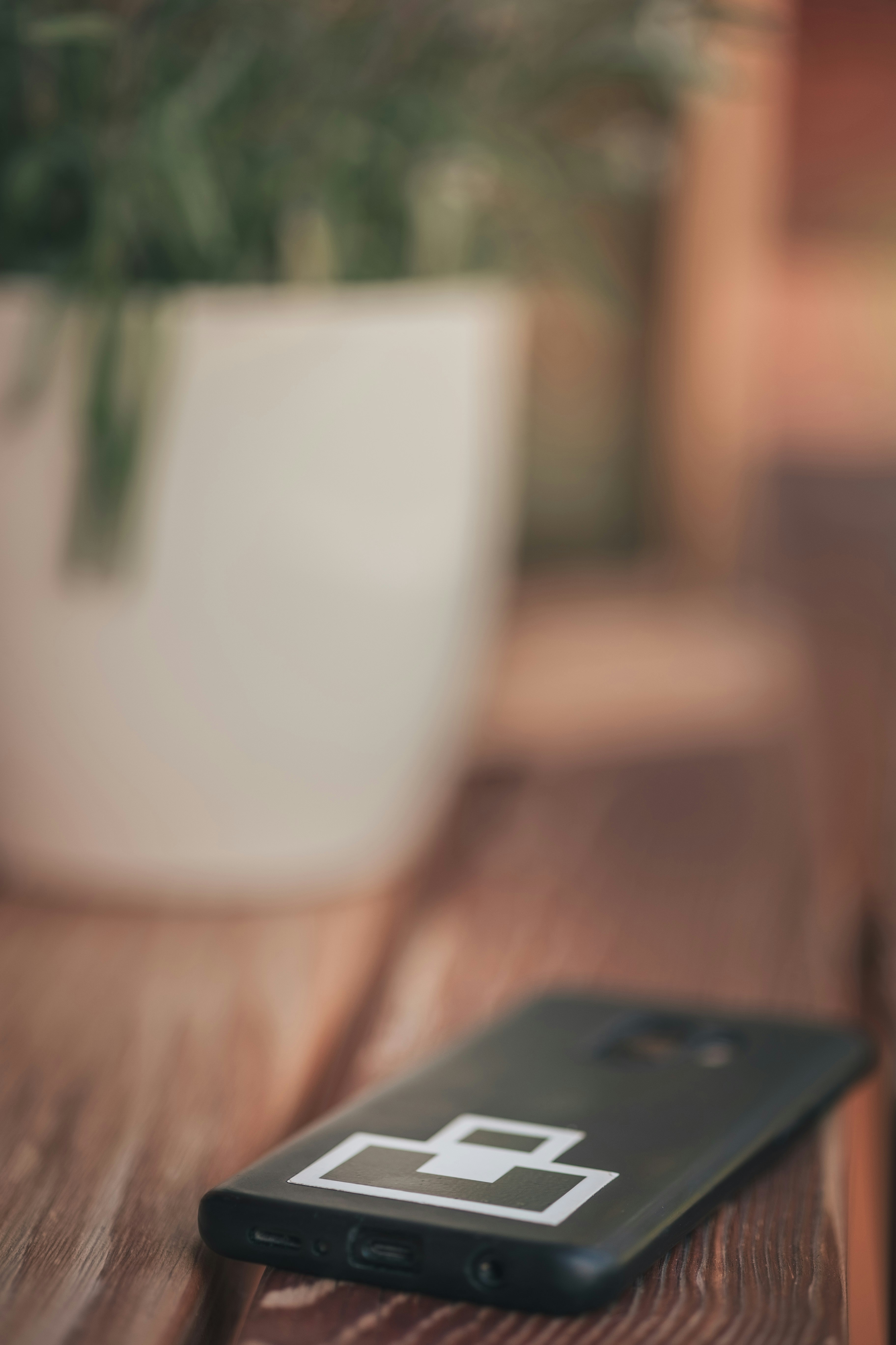 black smartphone on white ceramic mug